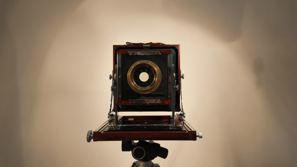 The restored Tachihara 8×10 wooden field camera on a tripod, viewed from the front.