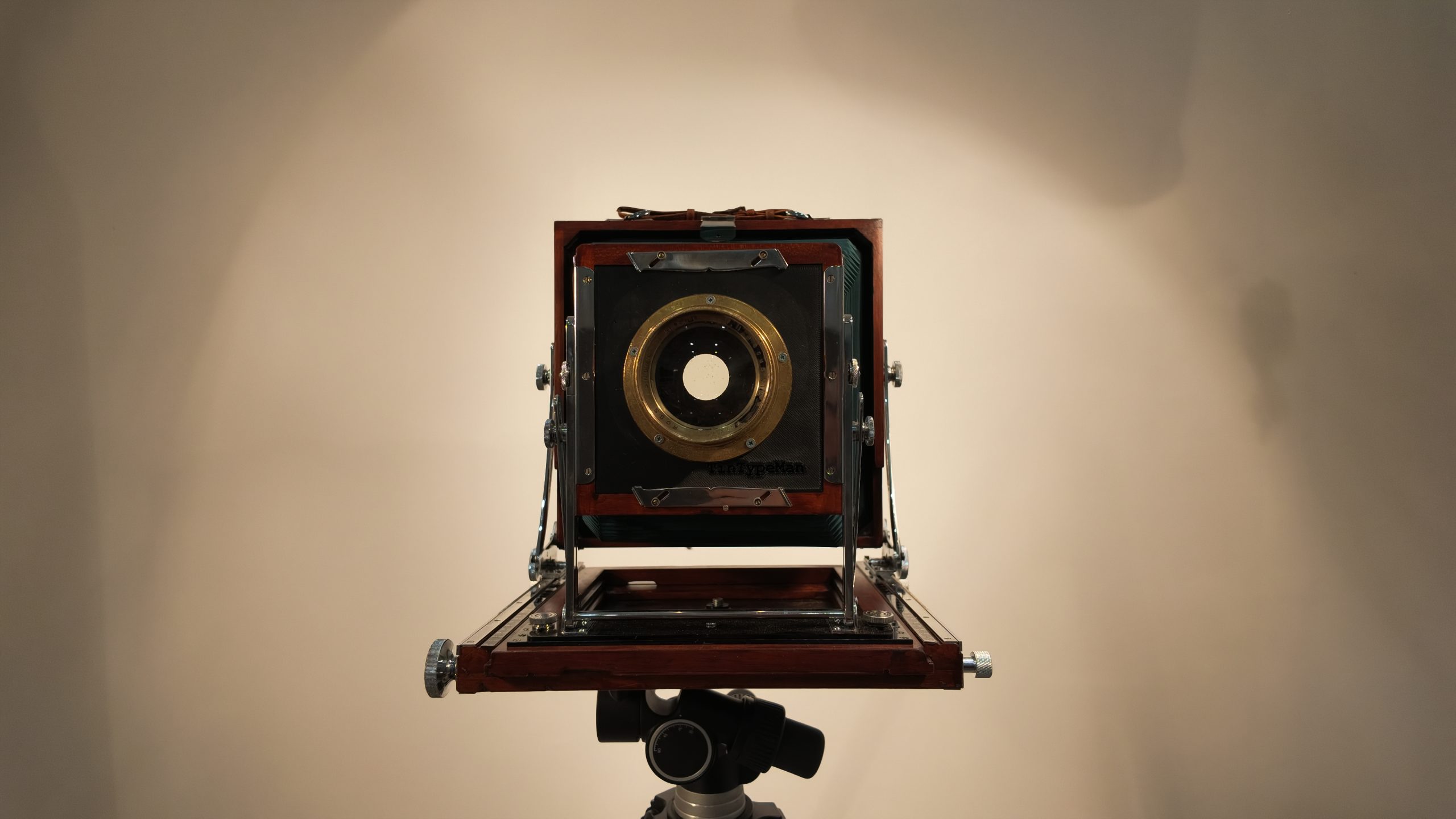 The restored Tachihara 8×10 wooden field camera on a tripod, viewed from the front.