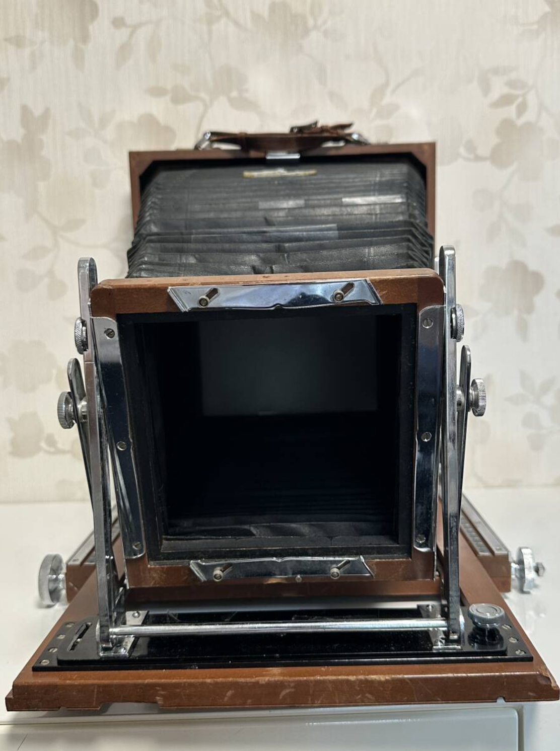 Front view of the Tachihara 8×10 before restoration, showing worn woodwork and the empty lens opening.