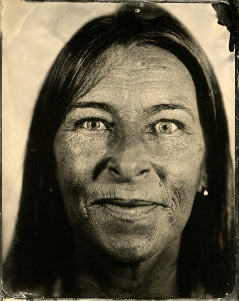 Close-up wetplate portrait of a woman looking directly at the camera.