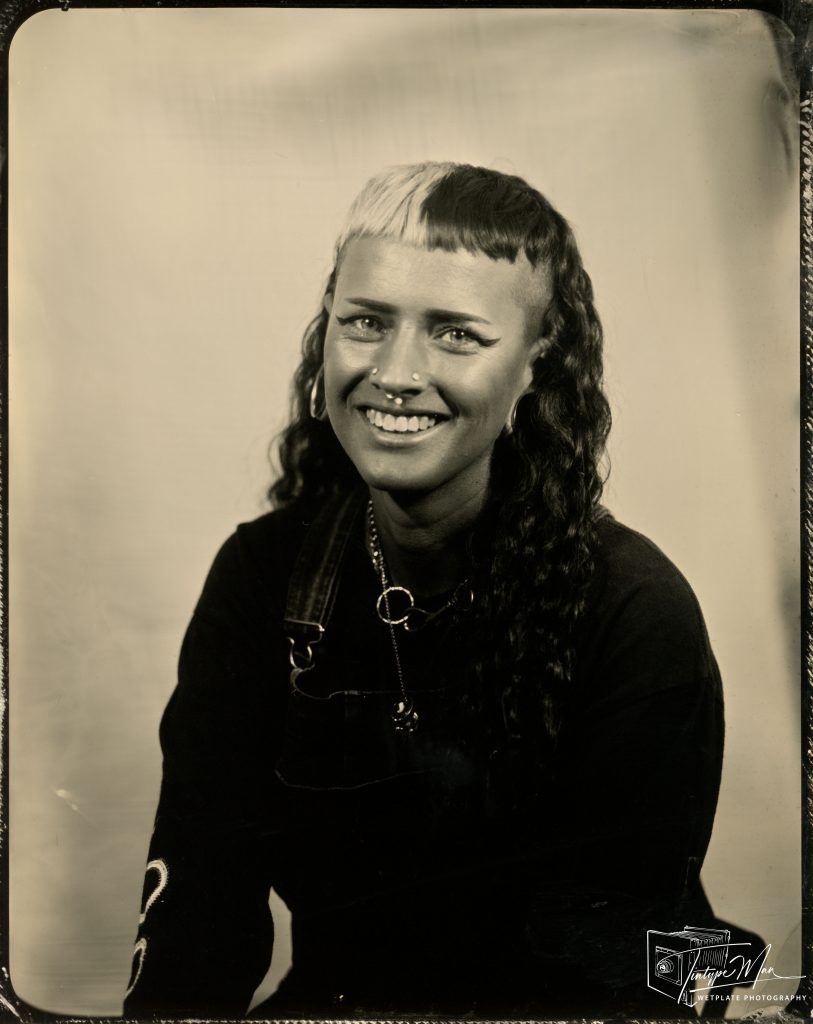 Wetplate portrait of a smiling woman with long wavy hair